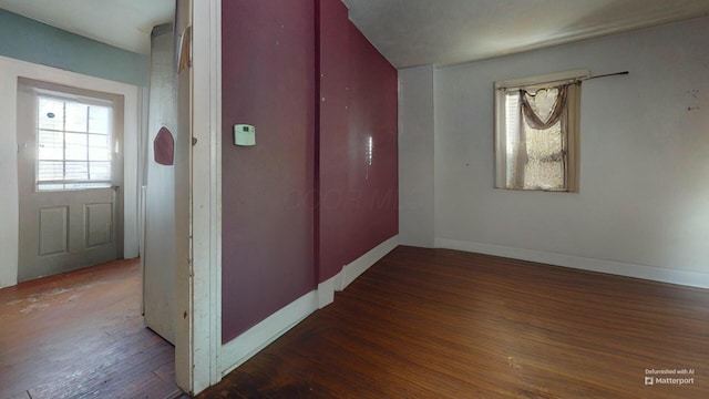 hallway featuring a wealth of natural light and dark hardwood / wood-style flooring