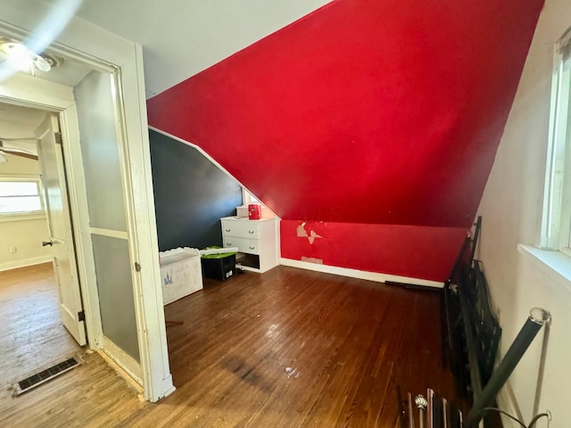 bonus room with hardwood / wood-style floors and lofted ceiling