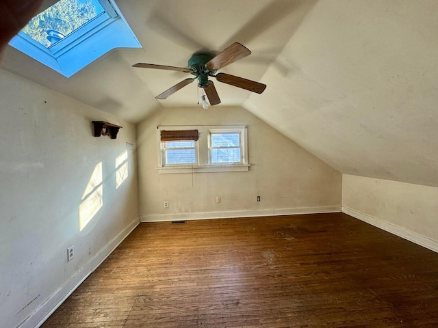 bonus room featuring wood-type flooring and lofted ceiling with skylight