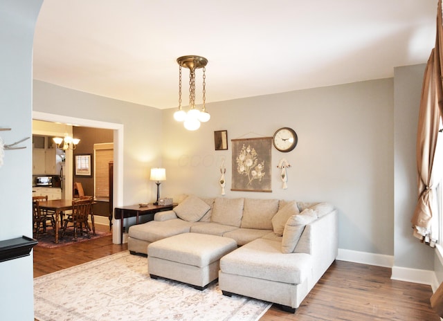 living room with hardwood / wood-style flooring and a chandelier