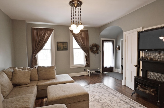 living room featuring a healthy amount of sunlight and dark hardwood / wood-style floors