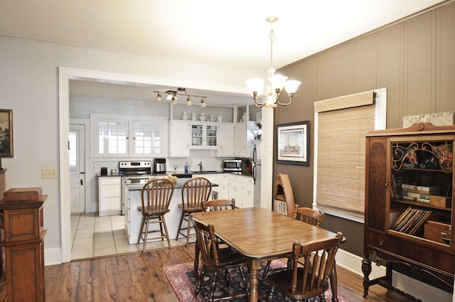 dining area featuring a chandelier and light wood-type flooring