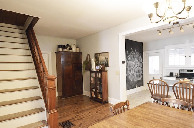 dining room featuring wood-type flooring and a notable chandelier