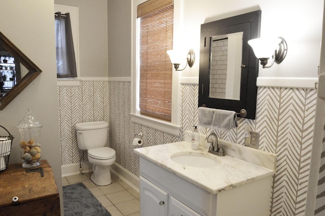 bathroom featuring tile patterned floors, vanity, and toilet