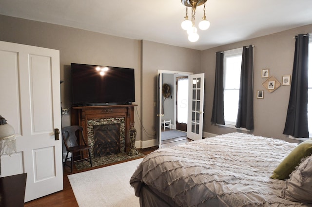 bedroom featuring dark hardwood / wood-style flooring and a fireplace