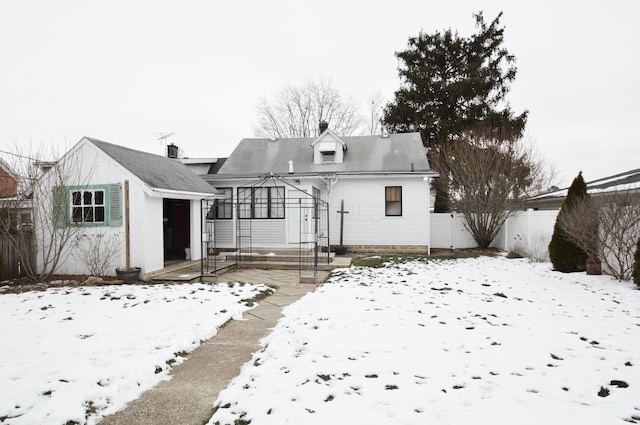 view of snow covered back of property