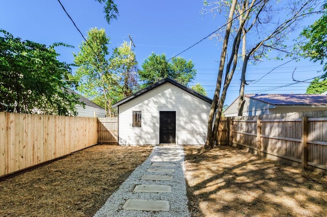 back of house with an outdoor structure