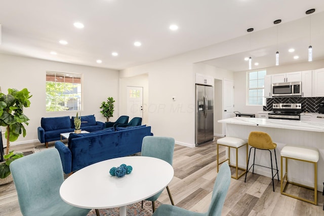 dining space with light hardwood / wood-style floors