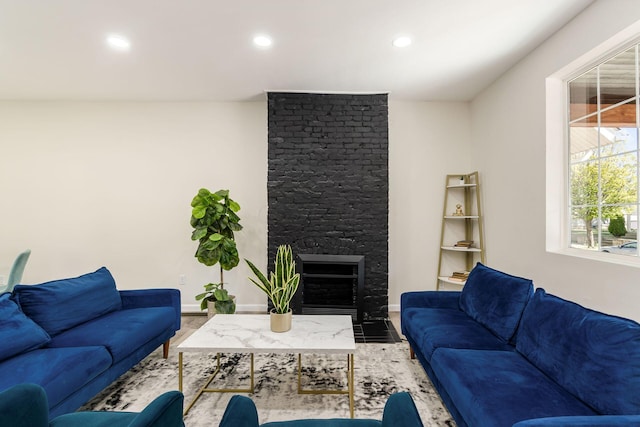 living room featuring a fireplace and a wealth of natural light