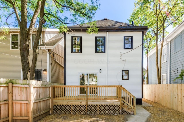 back of property featuring a wooden deck