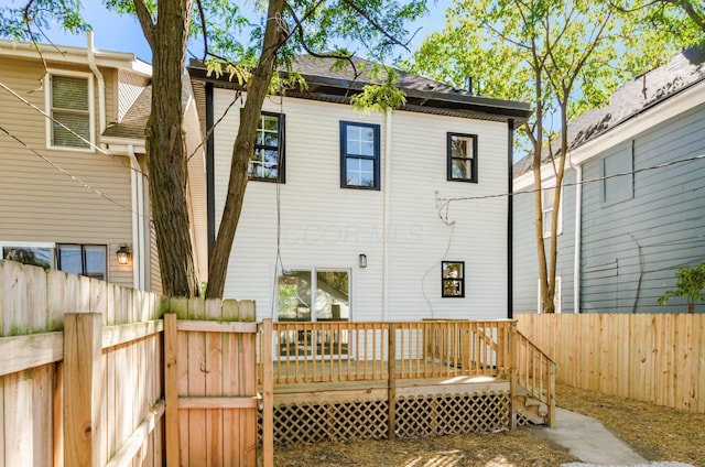 back of property with a wooden deck