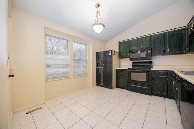 kitchen featuring pendant lighting, light tile patterned flooring, vaulted ceiling, and black appliances