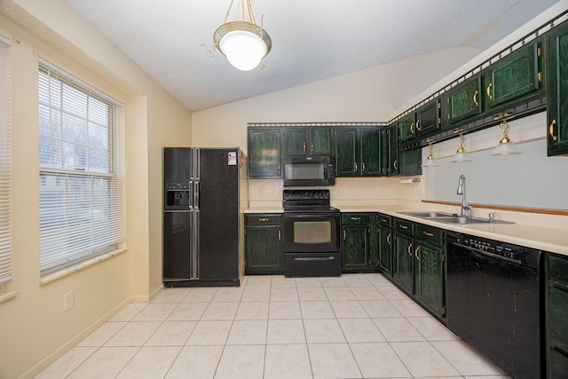 kitchen featuring light tile patterned floors, sink, vaulted ceiling, and black appliances