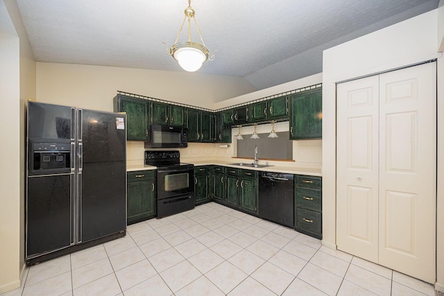 kitchen with sink, vaulted ceiling, light tile patterned floors, green cabinets, and black appliances