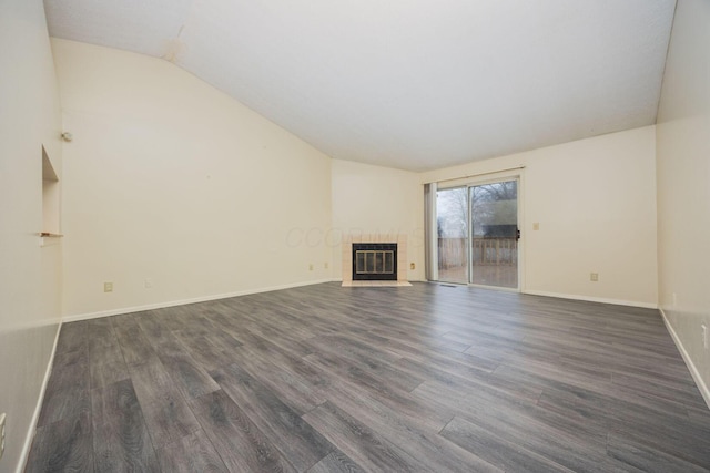 unfurnished living room with lofted ceiling, a fireplace, dark hardwood / wood-style flooring, and heating unit