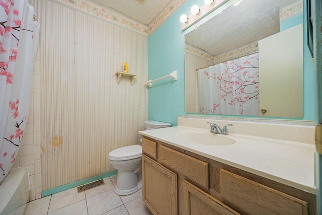 full bathroom with vanity, toilet, shower / bath combo, tile patterned floors, and a textured ceiling