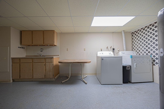 clothes washing area with cabinets and independent washer and dryer