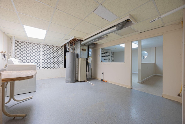 basement with water heater, heating unit, a paneled ceiling, and washer and clothes dryer