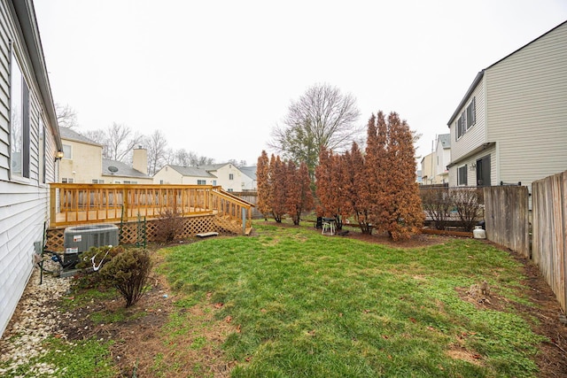 view of yard featuring a deck and central air condition unit