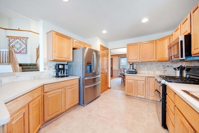 kitchen featuring tasteful backsplash, stainless steel appliances, and light brown cabinets