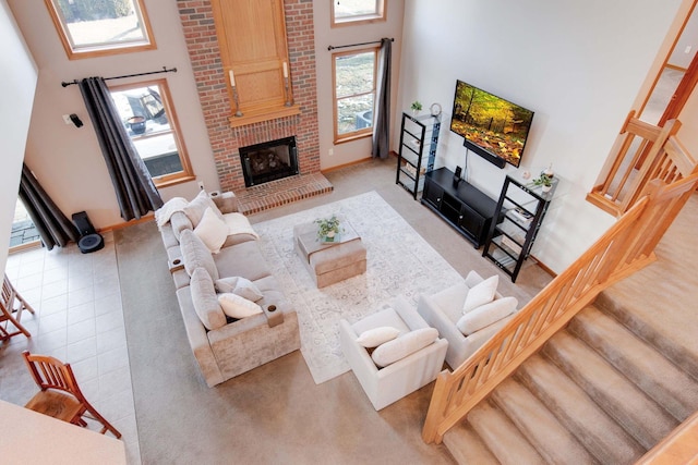 living room featuring a high ceiling and a fireplace