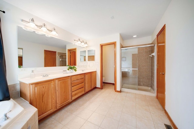 full bathroom featuring tile patterned floors, vanity, toilet, and independent shower and bath