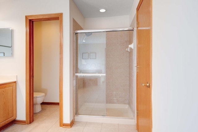 bathroom featuring walk in shower, tile patterned floors, vanity, and toilet