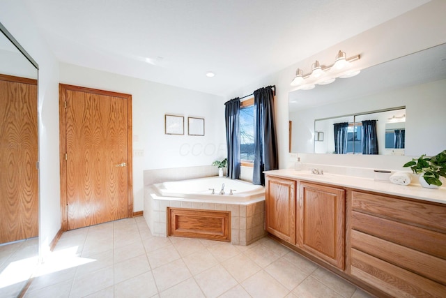 bathroom with vanity, tile patterned floors, and tiled bath