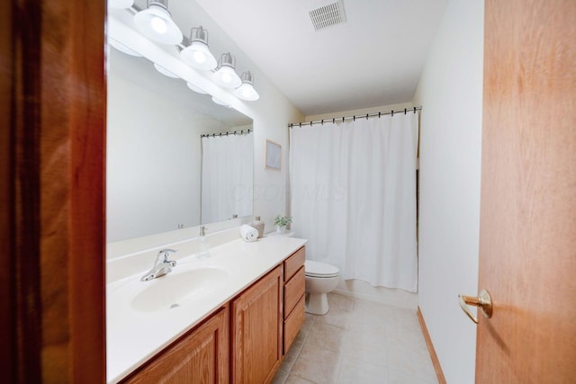 full bathroom featuring tile patterned flooring, vanity, shower / tub combo, and toilet