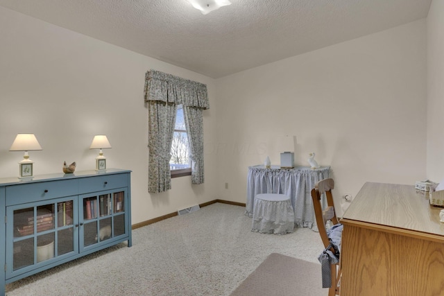 home office featuring visible vents, carpet flooring, a textured ceiling, and baseboards