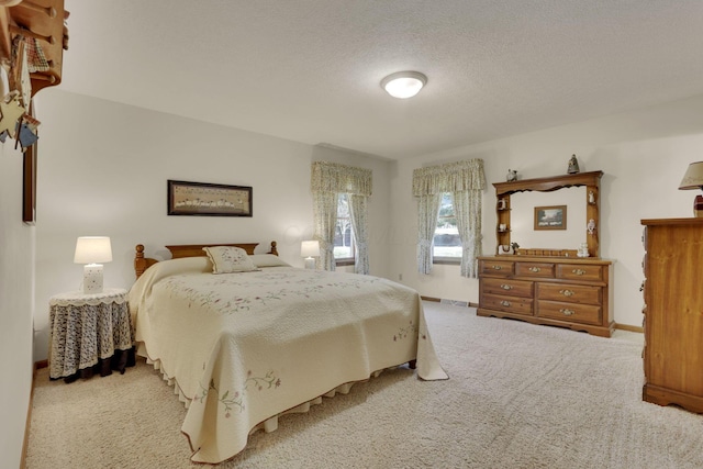 carpeted bedroom with baseboards and a textured ceiling