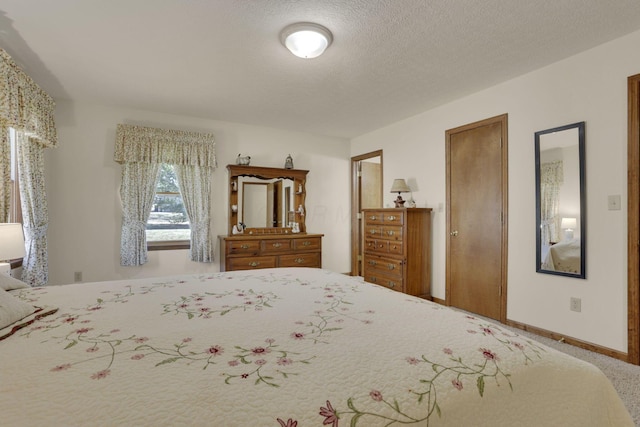 unfurnished bedroom featuring baseboards and a textured ceiling