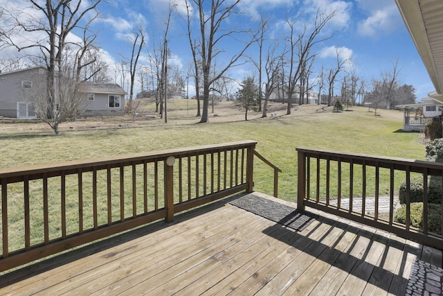 wooden deck featuring a yard