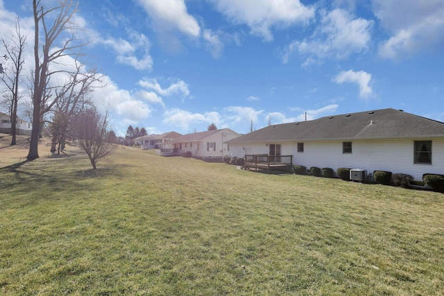 view of yard featuring central air condition unit and a deck