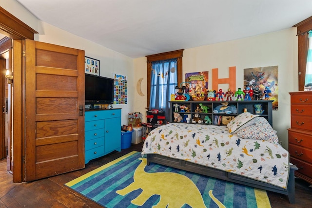 bedroom with dark hardwood / wood-style floors