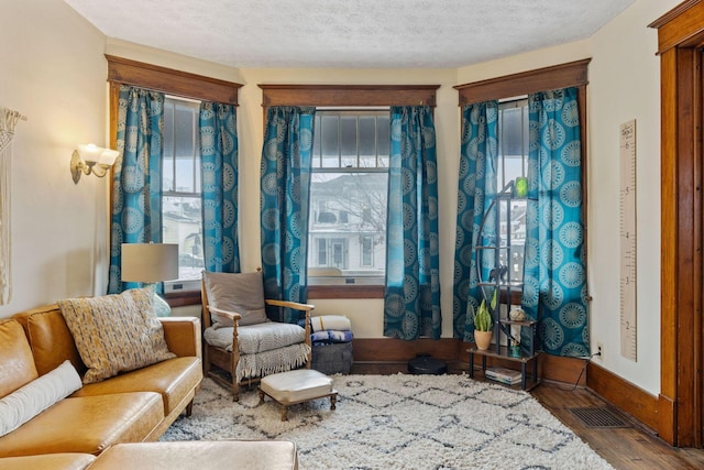 sitting room featuring hardwood / wood-style floors and a textured ceiling