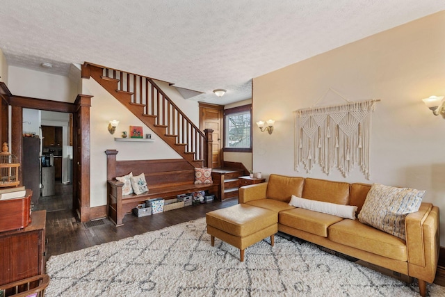 living room featuring dark hardwood / wood-style flooring and a textured ceiling