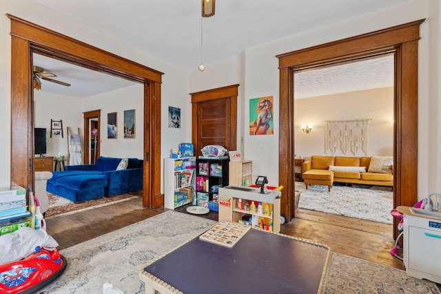 bedroom with dark hardwood / wood-style floors and ceiling fan