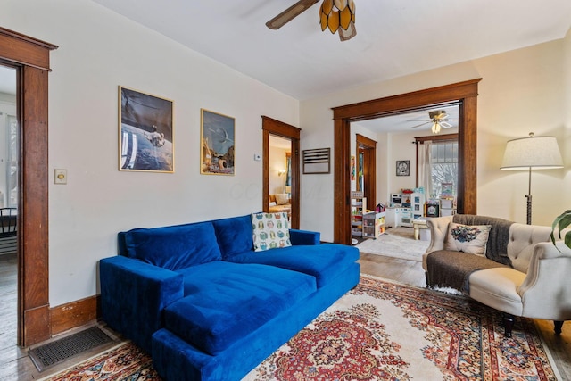 living room with wood-type flooring and ceiling fan