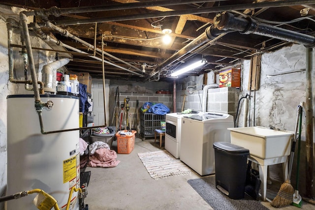 basement featuring washer and dryer and water heater