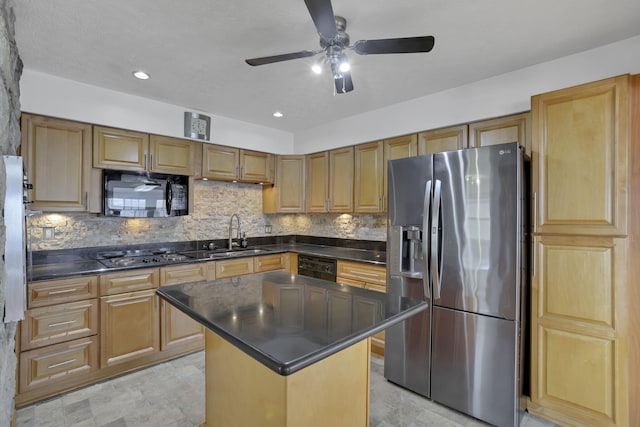 kitchen with a kitchen island, sink, decorative backsplash, ceiling fan, and black appliances