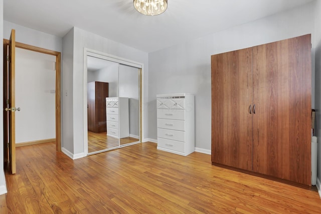 unfurnished bedroom featuring a closet and light hardwood / wood-style flooring