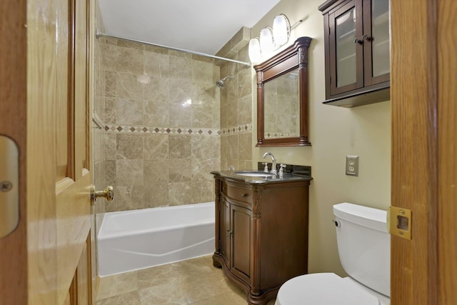 full bathroom with tile patterned floors, vanity, toilet, and tiled shower / bath combo