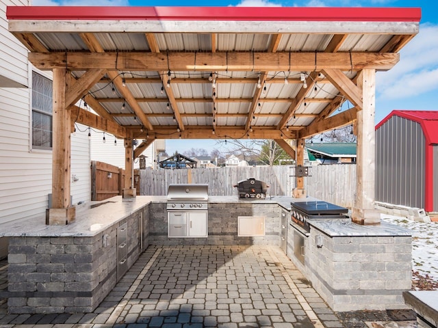 view of patio / terrace featuring a grill and an outdoor kitchen