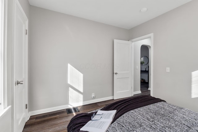 bedroom featuring dark wood-type flooring