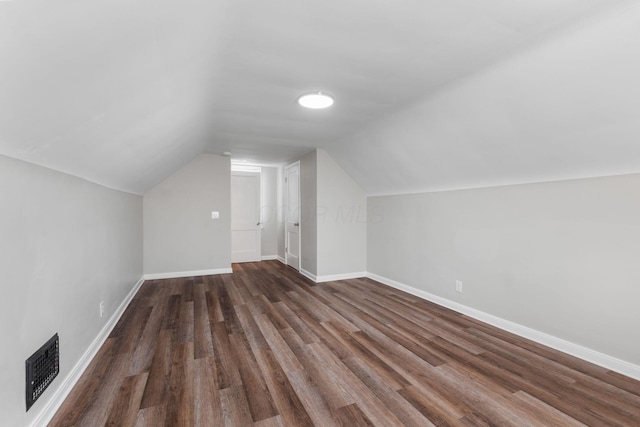 additional living space with lofted ceiling and dark hardwood / wood-style floors