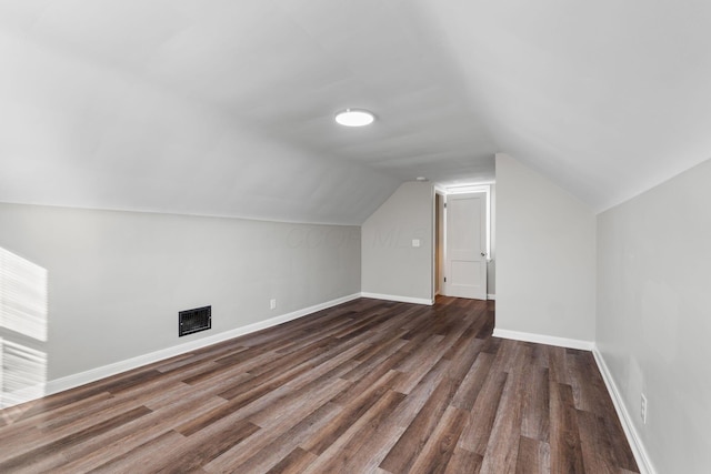 bonus room featuring lofted ceiling and dark hardwood / wood-style floors