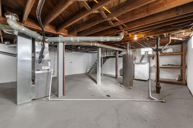 basement with heating unit, washer / clothes dryer, and water heater