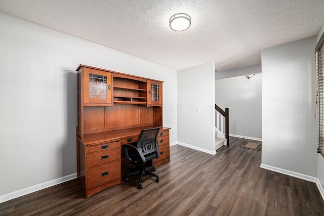 office with a textured ceiling and dark hardwood / wood-style flooring