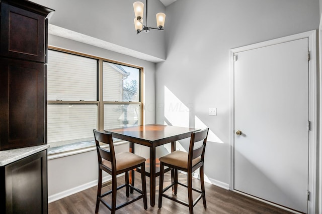 dining room with an inviting chandelier and dark hardwood / wood-style flooring